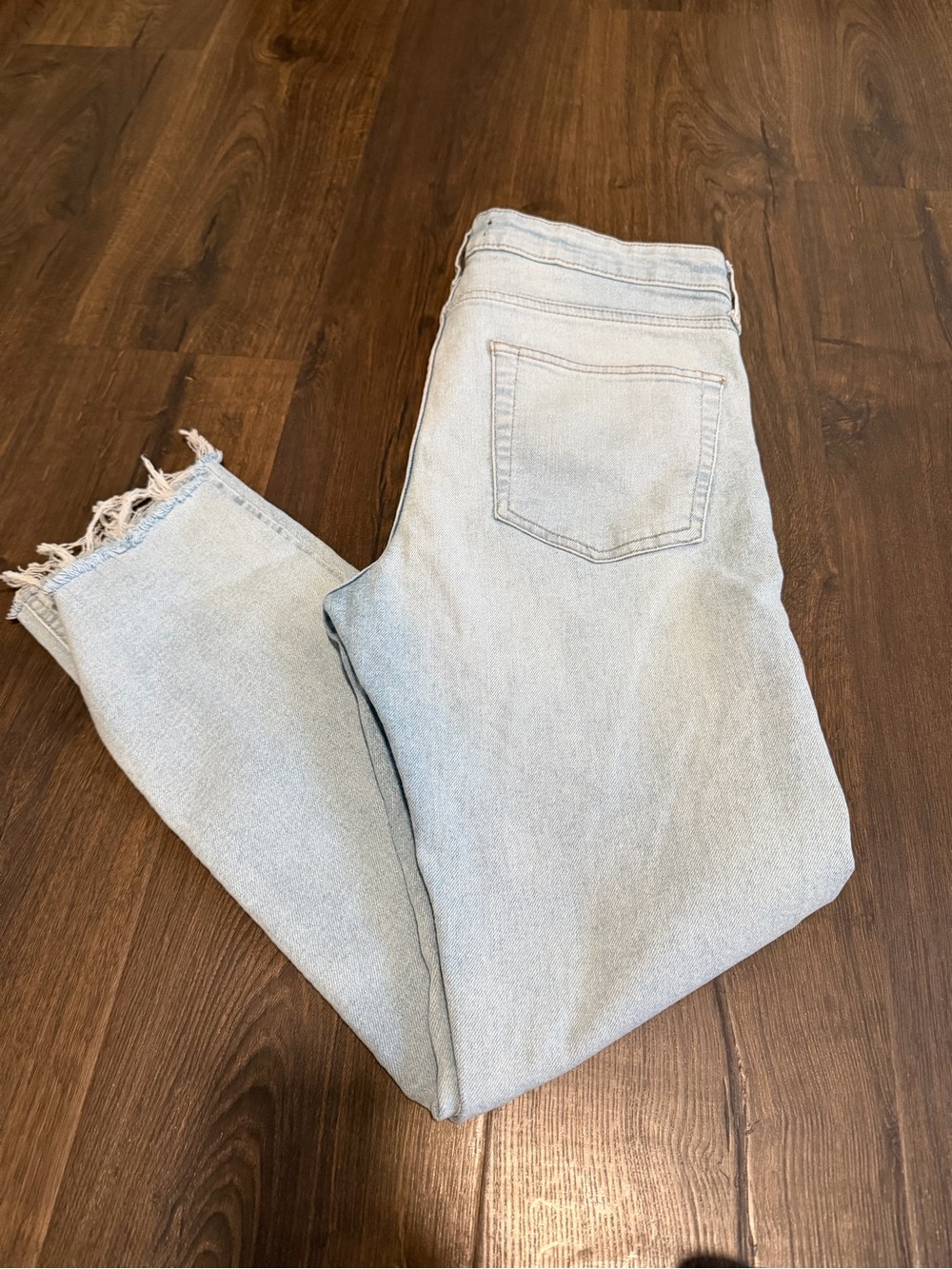 Men’s 32 light wash, distressed hem jeans